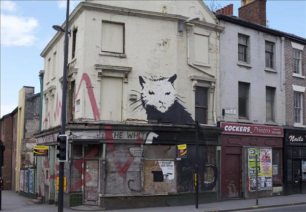 The view of derelict The Whitehouse pub on corner of Berry Street and Duke Street, showing Banksy's Rat.